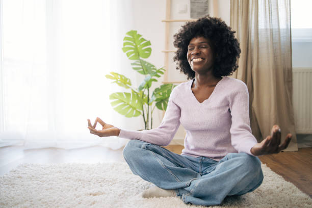 istock Young African American lady practicing yoga at home 2005665468