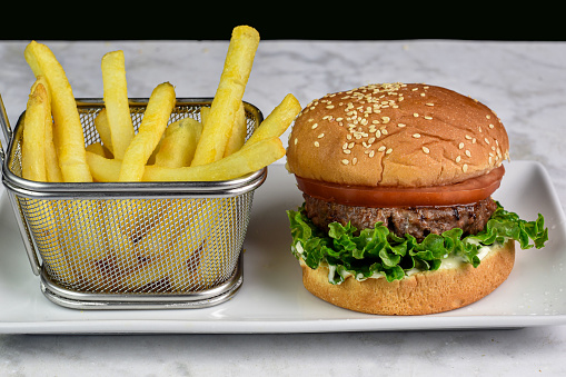 vegguie burger  with lettuce and tomato  served with fries