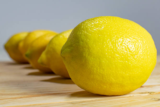 Natural, fresh and healthy lemons arranged on a wooden table