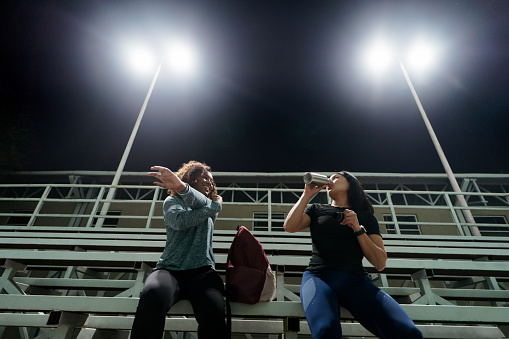With determination in their hearts, two young women embark on a late-night workout session, driven by their commitment to prioritize fitness in their busy lives.