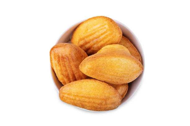 istock Madeleine cakes in a white bowl on a white isolated background 2005718844