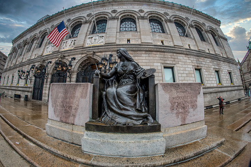A sculpture representing “Art” sits at the right front of the Boston Public Library in Back Bay.  \n\nThe sculptor was Bela Pratt (1867-1917,) and this work was installed at the Library in 1912.