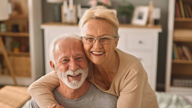 istock Happy elderly couple hugging indoors 2005725169