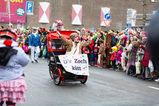 Cologne, Germany - February 11, 2024: On Carnival Sunday in Cologne, there are the traditional parades of schools and societies,(Schull- un Veedelszöch), here a rickshaw with the announcement: D´r Zoch kütt (the parade is coming)