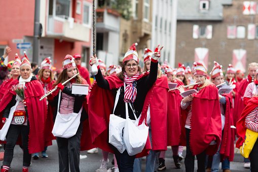 Cologne, Germany - February 11, 2024: On Carnival Sunday in Cologne, there are the traditional parades of schools and societies, Schull- un Veedelszöch, the participants are usually wearing self made costumes, here the marching band of the Erzbischöfliches Ursulinengymnasium