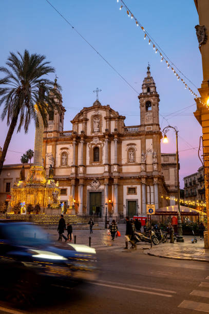 San Domenico is a Baroque-style Roman Catholic church, located on Piazza San Domenico, and located in the ancient quarter of La Loggia, in central Palermo, region of Sicily, Italy Palermo, Italy - December 24, 2022: A vibrant and bustling town square in san Domenico, Palermo, Italy, adorned with towering palm trees and a magnificent cathedral, all basking in the warm glow of a stunning blue hour. Nestled within the ancient quarter of La Loggia, this architectural masterpiece is a testament to Sicily's rich cultural heritage. piazza san domenico stock pictures, royalty-free photos & images