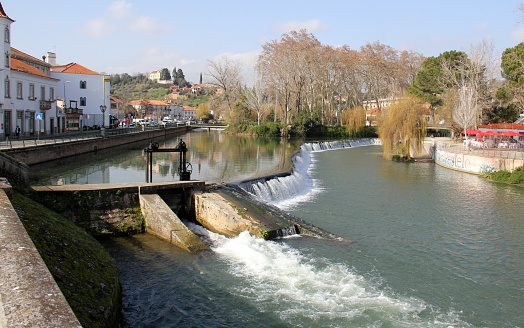 Lock on the dam by The Old Bridge, Ponte Velha, over Nabanus River, in the old town, Tomar, Portugal