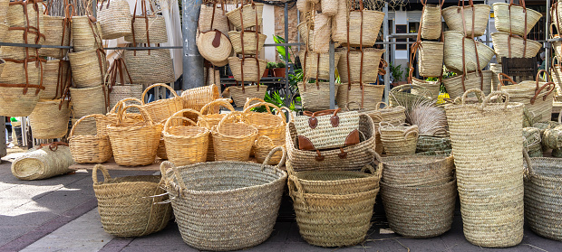 Various handcrafted wicker baskets showcased outdoors.