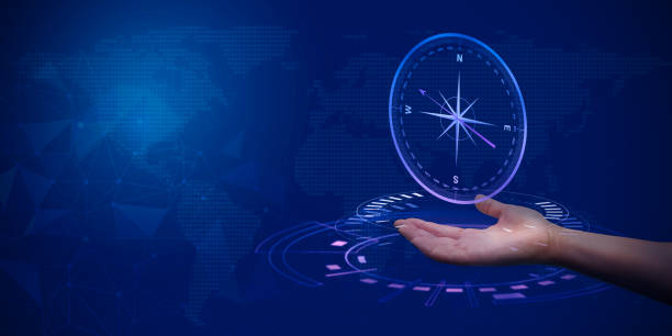 istock Explore World. Hand with symbolic compass against world map on dark blue background. Ideal for travel, adventure, and exploration concepts. Copy space 2005764921