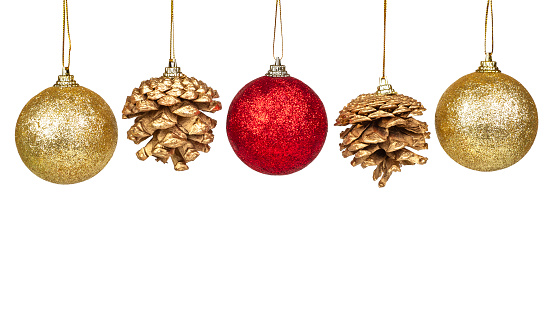 Group of colorful christmas tree baubles hangers in gold and red with pine cones isolated on white background