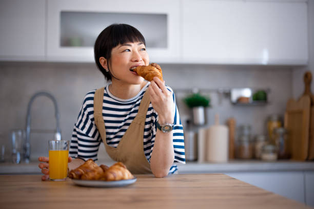 istock Japanese woman eating in the kitchen 2005840394