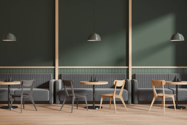 istock Stylish green cafe interior with chairs and table with couch 2005861910