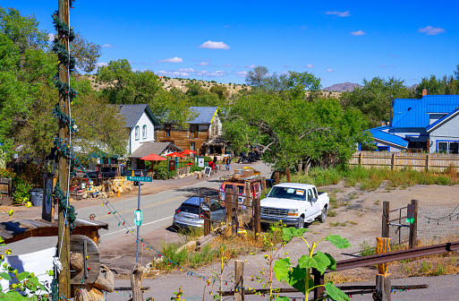 Santa Fe, New Mexico, USA - September 14, 2023: View at the Main Street of Madrid, New Mexico, or the Turquoise Trail with houses and parked cars on s summer day.