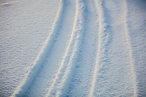 Snow texture with tire tracks.
