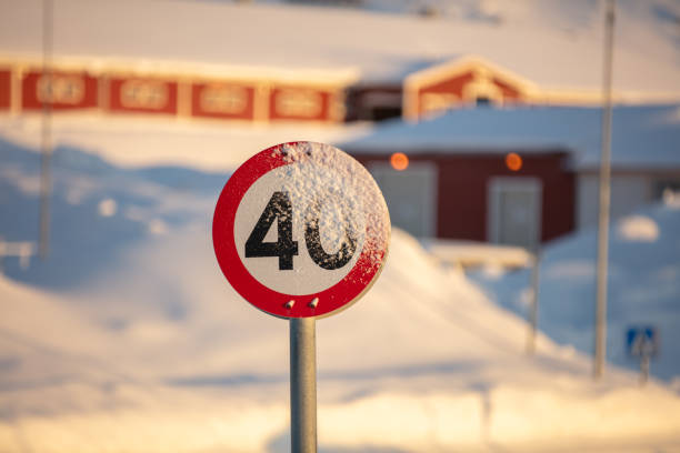 Funny warning sign indicating the presence of trolls in a snowy forest in winter in Norway.