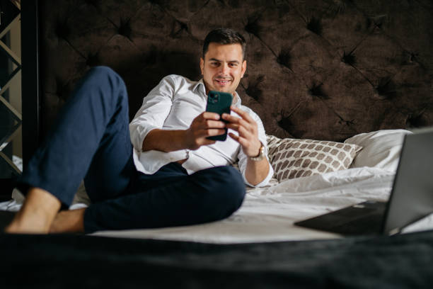 istock Using a Laptop and a cellphone in my bedroom 2005883509