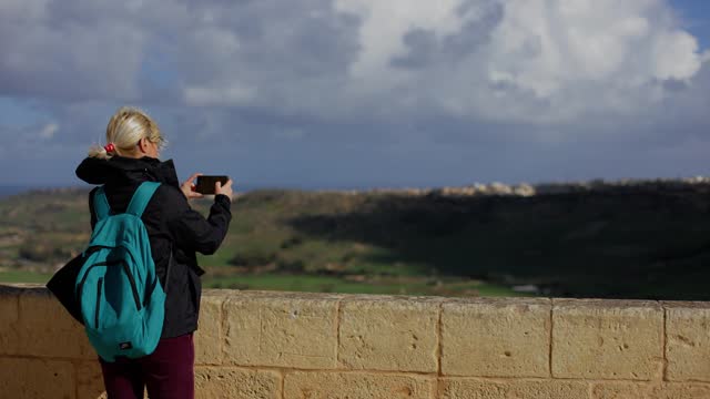Mature woman on historical and education travel - Cittadella Gozo,Malta