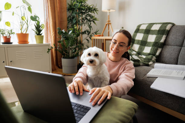 istock Young girl studying with her dog sitting in her lap 2005886169