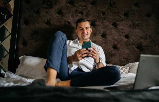 istock Finishing my work on a bed in my hotel room 2005887773