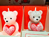 Candle in the shape of a bear with a heart. Valentines day concept