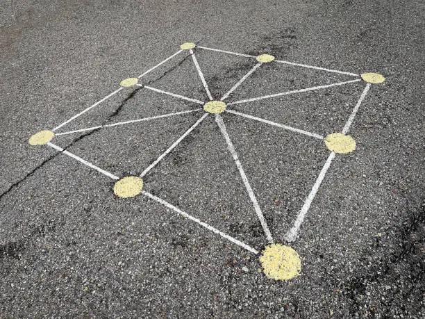 Photo of tic-tac-toe game board painted on the asphalt of a street, street games, popular games