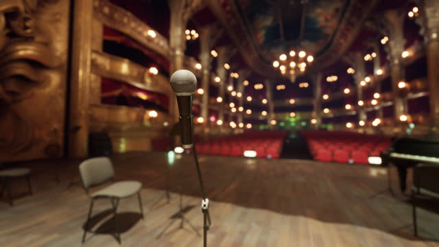 An empty stage with chairs and a microphone
