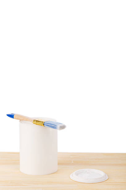 white paint with a brush on a wooden background with texture close-up