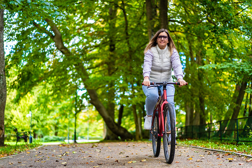Woman riding bike in city park