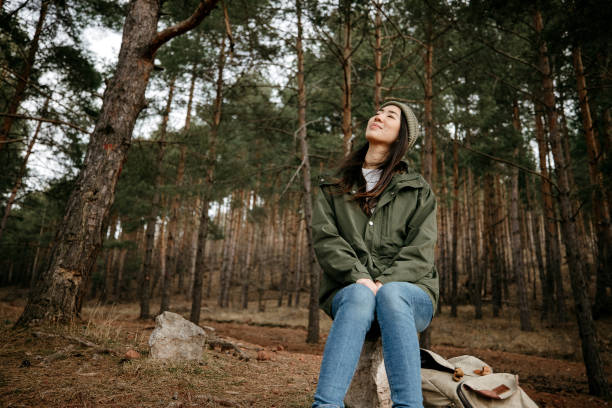 Beautiful woman enjoying nature in green forest