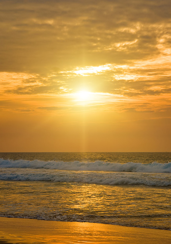Bright golden sunrise over the tropical sea.