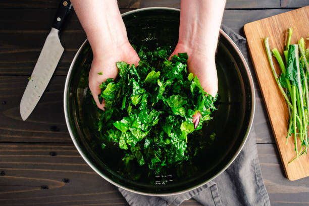 Massaging Chopped Tuscan Kale Leaves in Olive Oil