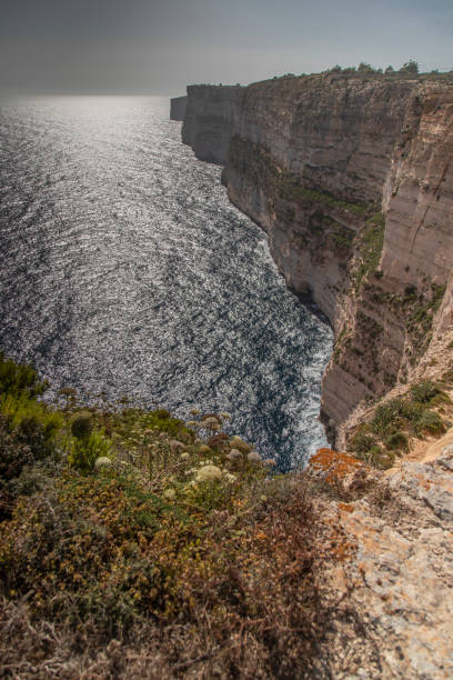istock Sunset over the ocean with beautiful sunlight in Ta Cenc cliffs in Malta 2005993389