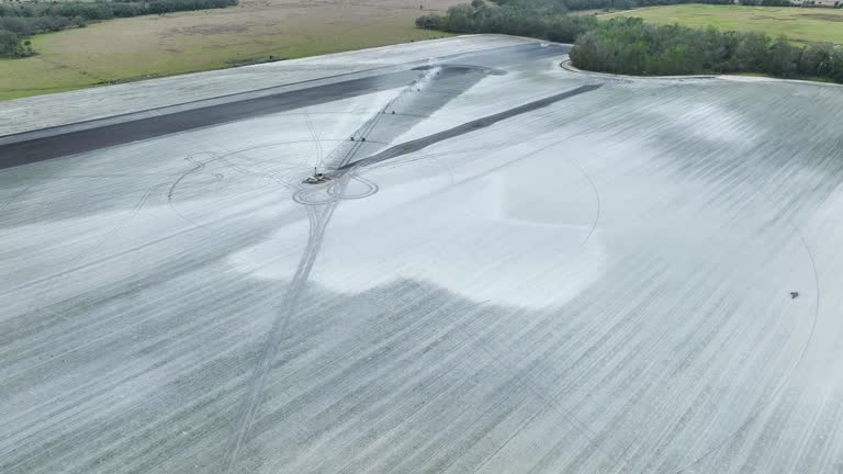 Sprinkler irrigation system watering farm field during dry season. Spraying water on farmland ground for crop growth during period of drought