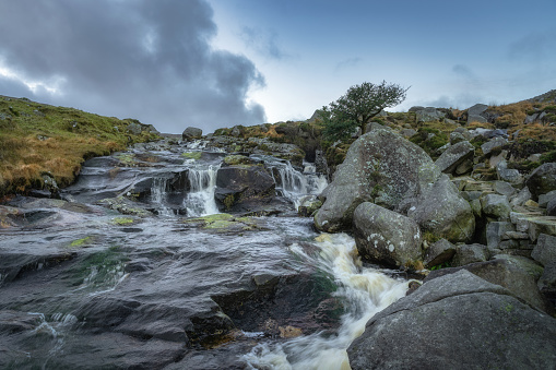 Stream with small waterfalls and cascades in Glendalough. Hiking in beautiful autumn Wicklow Mountains, Ireland