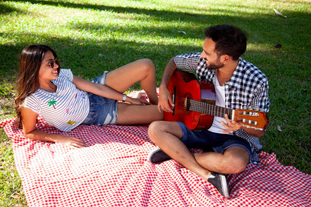 Young couple playing guitar stock photo