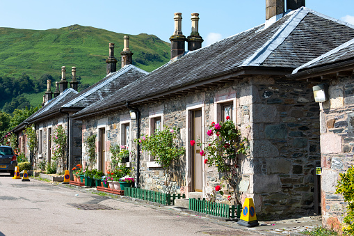 An image of Luss, Scotland, showcasing this charming village set on the banks of Loch Lomond. Known for its quaint cottages, beautiful gardens, and scenic waterfront, Luss embodies the tranquil beauty of the Scottish countryside, making it a picturesque and peaceful destination.