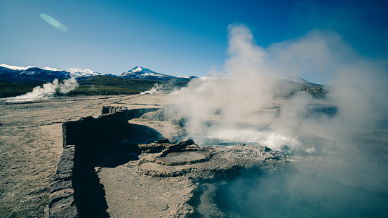White steam escapes from a hot spring of the El Tatio geysers in the Atacama Desert