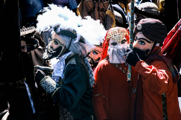 Annecy, France, March 15, 2014:  Portrait of a disguised person, posing in Annecy, France, during a Venetian Carnival which celebrates the beauty of the real Venice.