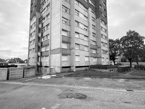 Strasbourg, France - Oct 17, 2020: Tall abandoned apartment building Habitation a Loyer Modere, generally called HLM, is a form of low-income housing in France, and other French speaking countries - black and white image