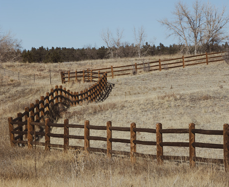 A split rail fence that really isn’t straight. It’s all over the place on a cold fall day