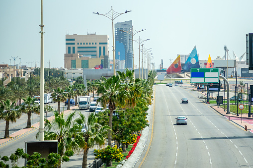 Road with cars and city downtown in background, Dammam, Saudi Arabia