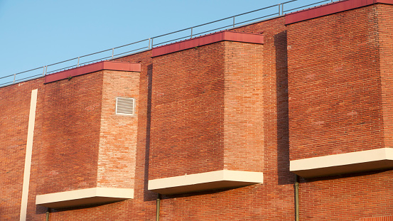 Volumes in brick building facade