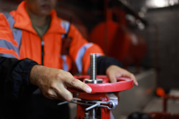 The Chief engineer checks the control system for security functions at the factory,