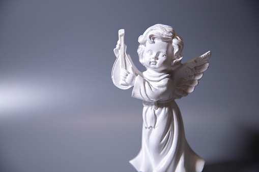 Angel sculpture in public cemetery of ¨Recoleta¨,(Buenos Aires, Argentina), isolated over white background.