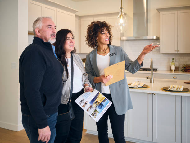 Real Estate Agent Showing a New Home to Prospective Buyers - Photo