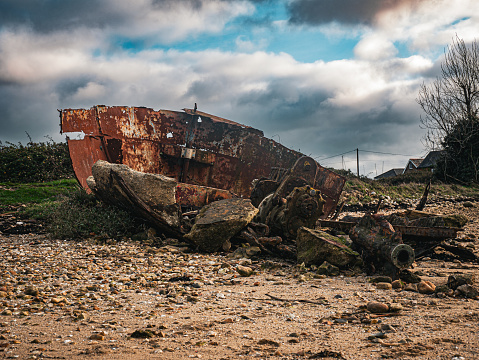 Rusty boat on the beach at The Duver, Isle of Wight. December 2023.
