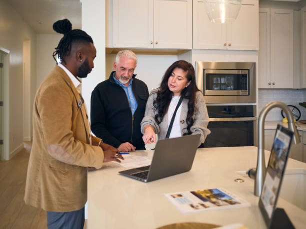 istock Real Estate Agent Showing a New Home to Prospective Buyers 2006245708