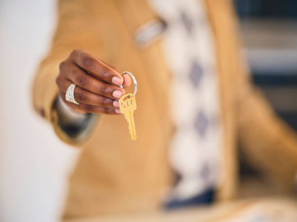 istock Real Estate Agent Holding a House Key 2006255283