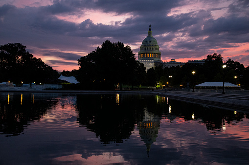 US Capitol at sunrise. Beautiful variety of colors in the sunrise mirrored in the Capitol Reflecting Pool.