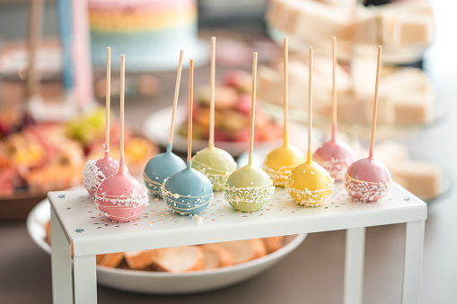 A charming array of pastel-colored cake pops decorated with sprinkles, adding a touch of sweetness to the baby shower festivities.